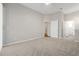 Large bedroom features neutral carpet and direct access to a private ensuite bathroom at 7521 Bay Port Rd # 12, Orlando, FL 32819