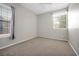 Sunlit bedroom with plush carpeting, window with curtains and blinds, offering a serene living space at 7521 Bay Port Rd # 12, Orlando, FL 32819