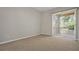 Spacious bedroom with neutral carpet and sliding glass doors to an outdoor balcony at 7521 Bay Port Rd # 12, Orlando, FL 32819