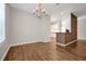 Bright dining room boasts wood floors and an elegant chandelier fixture above at 7521 Bay Port Rd # 12, Orlando, FL 32819