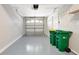 Clean and organized garage featuring epoxy flooring and overhead storage at 7521 Bay Port Rd # 12, Orlando, FL 32819