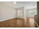 Bright living room featuring wood floors, a modern wall accent, and large windows with natural light at 7521 Bay Port Rd # 12, Orlando, FL 32819