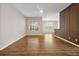 Bright living room featuring wood floors, a modern wall accent, and large windows with natural light at 7521 Bay Port Rd # 12, Orlando, FL 32819