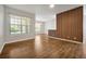 Bright living room featuring wood floors, a modern wall accent, and large windows with natural light at 7521 Bay Port Rd # 12, Orlando, FL 32819