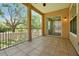 Covered patio with views of trees and a metal safety railing, ideal for relaxing outdoors at 7521 Bay Port Rd # 12, Orlando, FL 32819