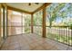 Screened patio with tile flooring providing a view of the surrounding trees and landscape at 7521 Bay Port Rd # 12, Orlando, FL 32819