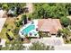 Aerial view of a community pool with lounge chairs, umbrellas, and nearby parking at 7521 Bay Port Rd # 12, Orlando, FL 32819
