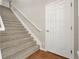 Carpeted staircase with wood railings leading to upper or lower levels at 7521 Bay Port Rd # 12, Orlando, FL 32819