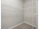 Walk-in closet with carpeted floor and metal shelving in a modern design at 7521 Bay Port Rd # 12, Orlando, FL 32819