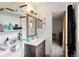 Bathroom with vanity, framed mirror, shelving unit, and decorative wall sconce at 8 Lake Jackson Dr, Mascotte, FL 34753