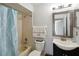 Cozy bathroom featuring a shower-tub combination, modern vanity, decorative mirror, and ample lighting at 8 Lake Jackson Dr, Mascotte, FL 34753