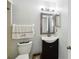 Cozy bathroom featuring a modern vanity, decorative mirror, and ample lighting, creating a fresh and inviting space at 8 Lake Jackson Dr, Mascotte, FL 34753