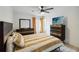 Bedroom featuring a ceiling fan, wood look tile floors, a bed, and windows with blinds at 8 Lake Jackson Dr, Mascotte, FL 34753