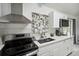 Well-lit kitchen featuring stainless steel appliances, white cabinets, and a stylish faucet at 8 Lake Jackson Dr, Mascotte, FL 34753