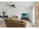 Bright living room featuring a ceiling fan, comfortable sofa, and dining area in the background at 8 Lake Jackson Dr, Mascotte, FL 34753