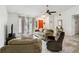 Inviting living room with tile floors, modern ceiling fan, comfortable seating, and bright red door at 8 Lake Jackson Dr, Mascotte, FL 34753