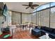 Inviting sunroom with tile flooring, comfortable seating area, ceiling fan, and views of the outdoor space at 8 Lake Jackson Dr, Mascotte, FL 34753