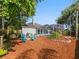 Backyard with seating area, fire pit, swing, landscaping, and pool at 809 Palmetto Ter, Oviedo, FL 32765