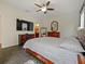 Bedroom boasts a TV, dresser and modern décor at 809 Palmetto Ter, Oviedo, FL 32765