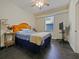 Neutral bedroom with tile floors, a ceiling fan, a large window, and furniture at 809 Palmetto Ter, Oviedo, FL 32765