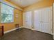 Bedroom with tile flooring, a large window with blinds, and a double door closet at 809 Palmetto Ter, Oviedo, FL 32765