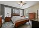 Well-lit bedroom features a ceiling fan and multiple windows with natural light at 809 Palmetto Ter, Oviedo, FL 32765