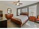 Spacious bedroom features a ceiling fan, dresser, and natural light at 809 Palmetto Ter, Oviedo, FL 32765