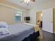 Bedroom with tile floors, ceiling fan, a window with blinds, and an ensuite bath at 809 Palmetto Ter, Oviedo, FL 32765