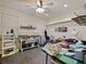 Large bonus room with sewing and craft accessories, pegboards, shelving, tile floors, and fan at 809 Palmetto Ter, Oviedo, FL 32765