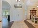 Welcoming foyer with double doors, high ceilings, and elegant decor at 809 Palmetto Ter, Oviedo, FL 32765