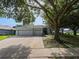 Charming home featuring a two-car garage, mature trees, and a well-maintained front yard at 809 Palmetto Ter, Oviedo, FL 32765