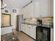 Modern kitchen features white cabinets, granite countertops and stainless steel appliances at 809 Palmetto Ter, Oviedo, FL 32765