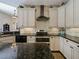 Modern kitchen features stainless steel appliances, granite countertops and white cabinets at 809 Palmetto Ter, Oviedo, FL 32765