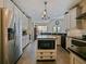 Bright kitchen features an island, stainless steel appliances and white cabinets at 809 Palmetto Ter, Oviedo, FL 32765