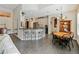 Open-concept kitchen features bar seating and flows into a dining area at 809 Palmetto Ter, Oviedo, FL 32765