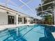 Screened-in pool with lush landscaping and inviting blue water at 809 Palmetto Ter, Oviedo, FL 32765