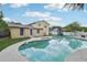 Large inground pool, play set, and green grass of this beautiful home in the backyard at 8652 Savory Dr, Orlando, FL 32825