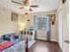 This bedroom features hardwood floors, ample sunlight, and bright décor at 8652 Savory Dr, Orlando, FL 32825