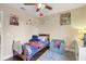 Bedroom with wood flooring, ceiling fan, and decorative wall art at 8652 Savory Dr, Orlando, FL 32825