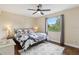 Bright bedroom with ceiling fan, large window with outdoor view, and hardwood floors at 8652 Savory Dr, Orlando, FL 32825