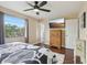 Spacious bedroom with hardwood floors, a ceiling fan, and a large window at 8652 Savory Dr, Orlando, FL 32825
