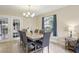 Dining room with a view to the patio, complemented by elegant furnishings and tiled flooring at 8652 Savory Dr, Orlando, FL 32825