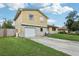View of the house's front featuring a stone facade and a two-car garage at 8652 Savory Dr, Orlando, FL 32825
