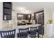 This kitchen features granite countertops, a breakfast bar, stainless steel appliances, and dark wood cabinetry at 8652 Savory Dr, Orlando, FL 32825