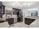 Kitchen boasts granite countertops, dark cabinetry, and stainless-steel appliances at 8652 Savory Dr, Orlando, FL 32825