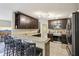 Modern kitchen equipped with stainless steel appliances, granite counters, and bar stool seating at 8652 Savory Dr, Orlando, FL 32825