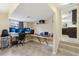 An additional home office features custom desk and multiple monitors at 8652 Savory Dr, Orlando, FL 32825