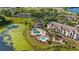 Aerial view showing complex with landscaping, pool, and lakeside views at 8801 Latrec Ave # 8107, Orlando, FL 32819