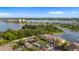 Aerial view of the apartment building and parking lot surrounded by green trees and lake at 8801 Latrec Ave # 8107, Orlando, FL 32819