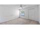Bright bedroom showcasing ceiling fan, carpet, and a double door closet at 8801 Latrec Ave # 8107, Orlando, FL 32819